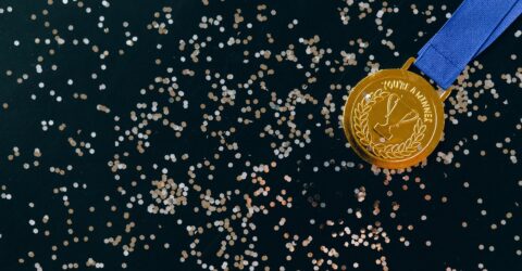 close up shot of a gold medal on a black surface